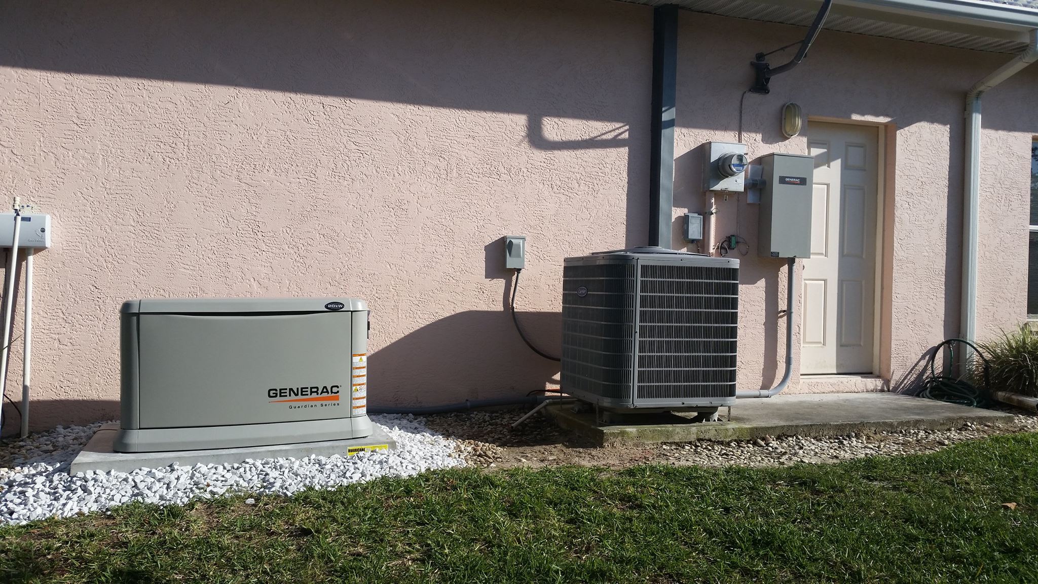 A Generac whole-home standby generator installed on the side of a Naples home by Dan House Electric