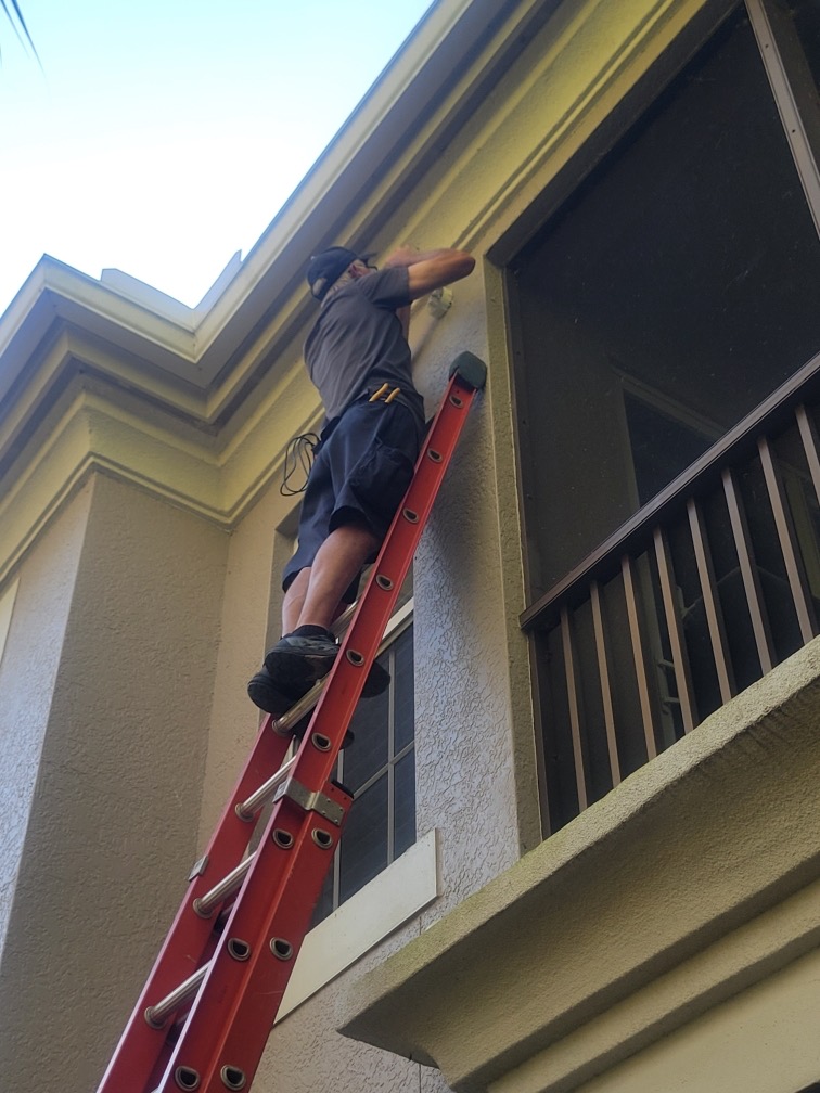 Dan House Electric electrician doing exterior fixture work from a ladder