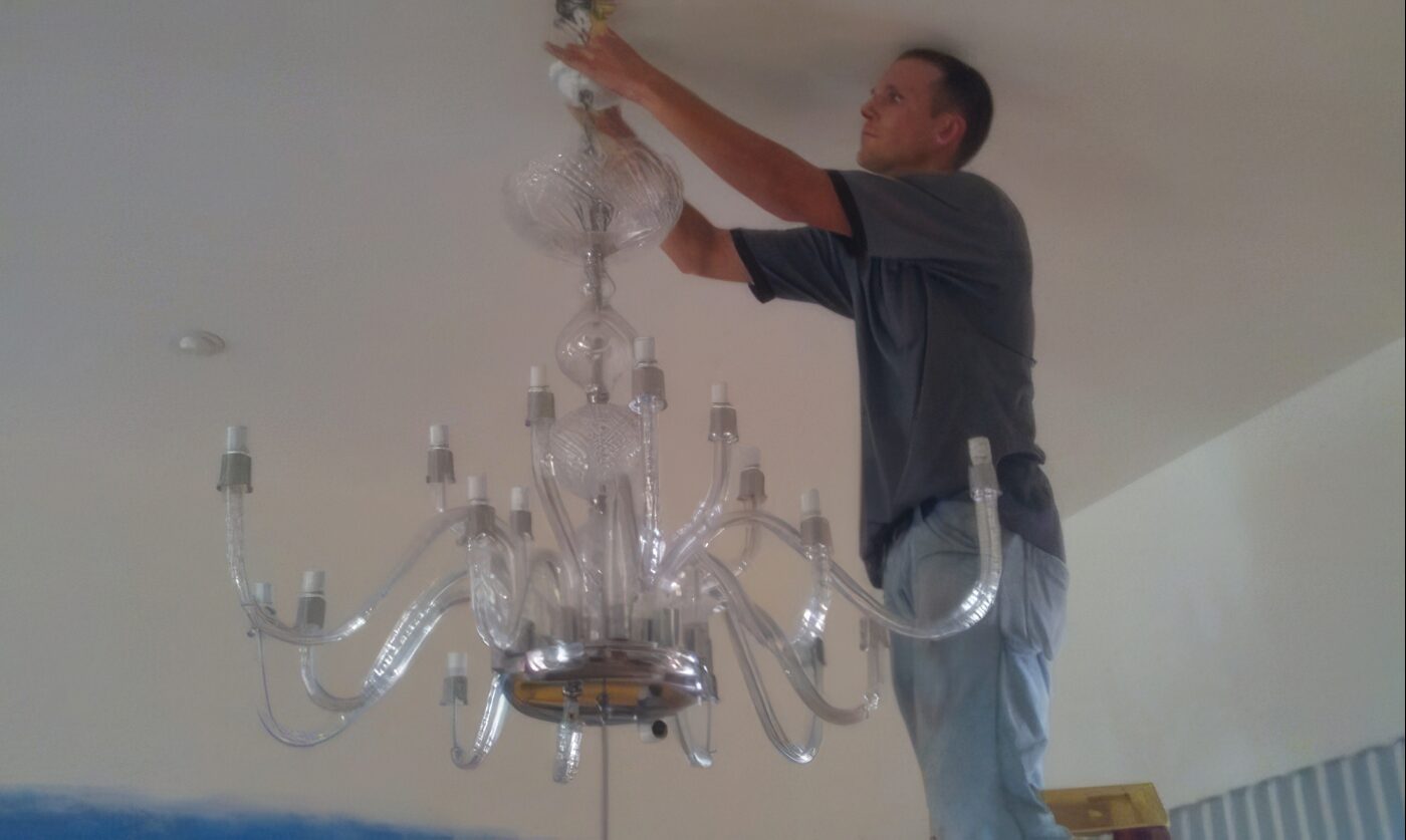 Dan House Electric installing a luxury crystal chandelier in a Southwest Florida home