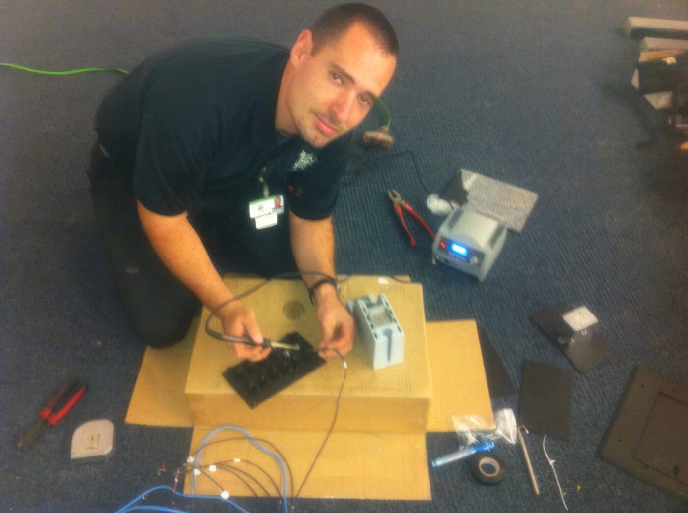 Dan House Electric technician wiring low-voltage CCTV and wireless equipment